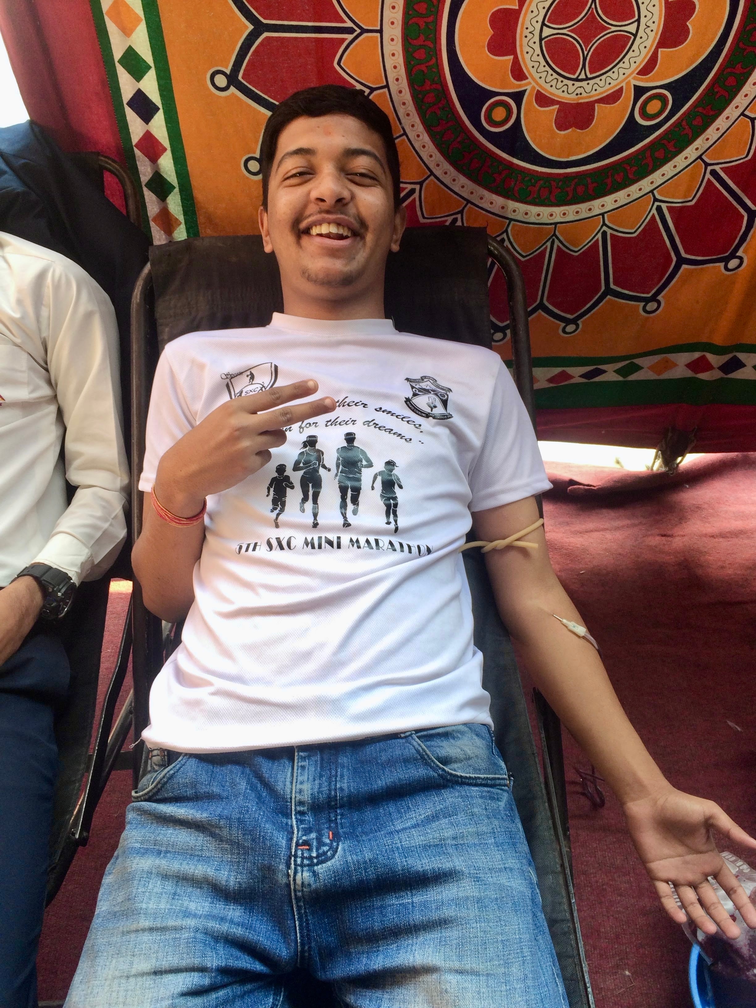 Rasil smiling while donating blood for the first time
