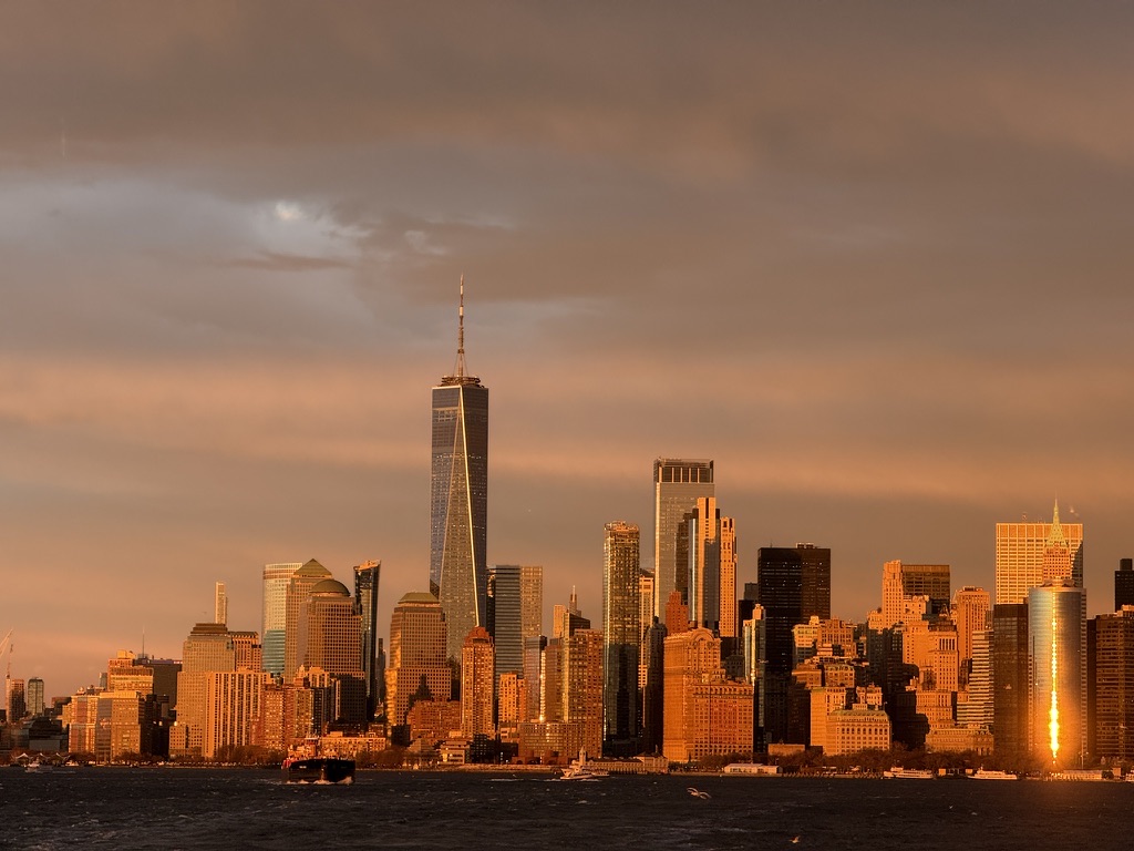 Lower Manhattan glowing orange in the final sunset of 2025