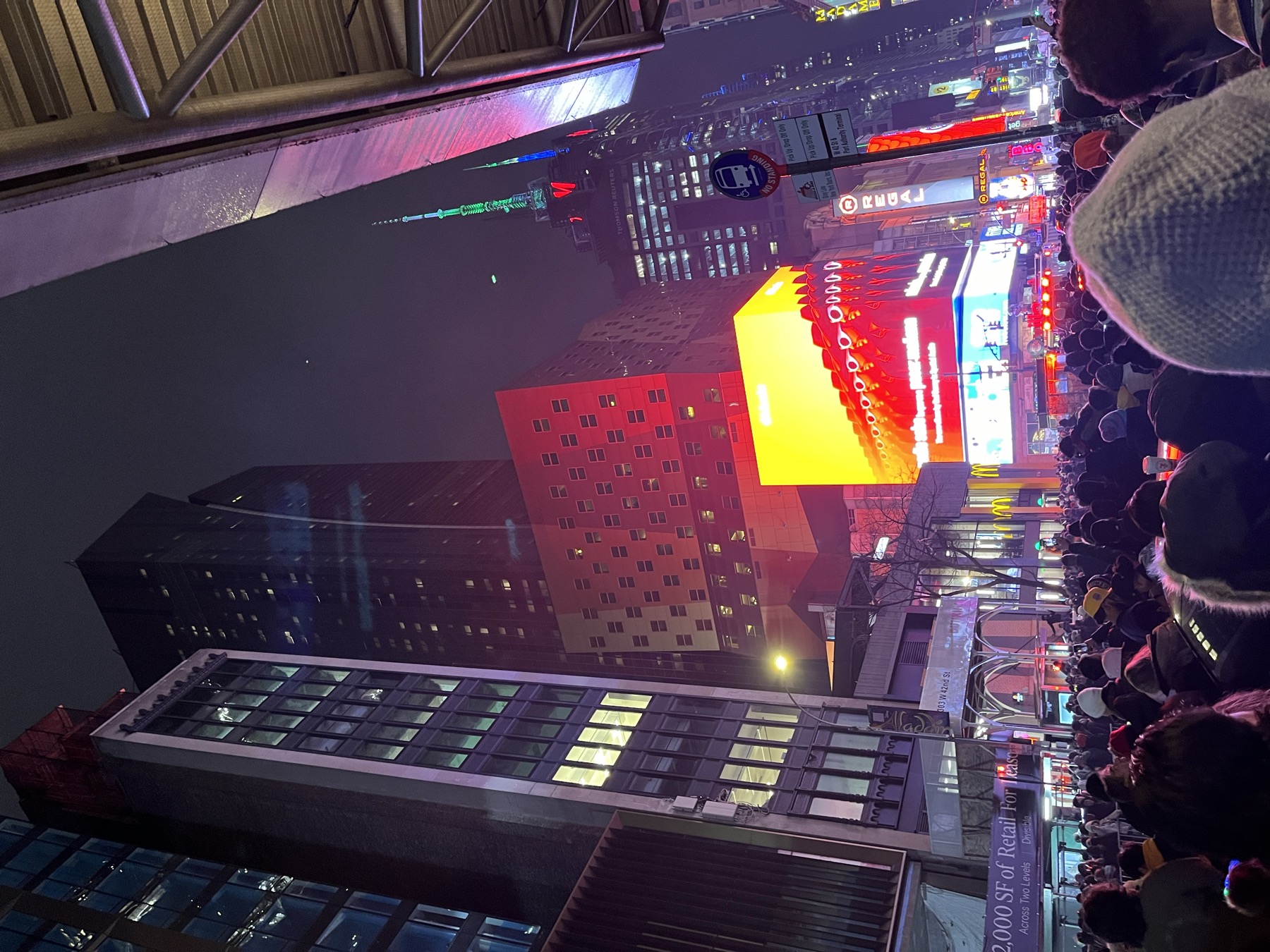 A dense New Year's Eve crowd beneath the lights near Times Square