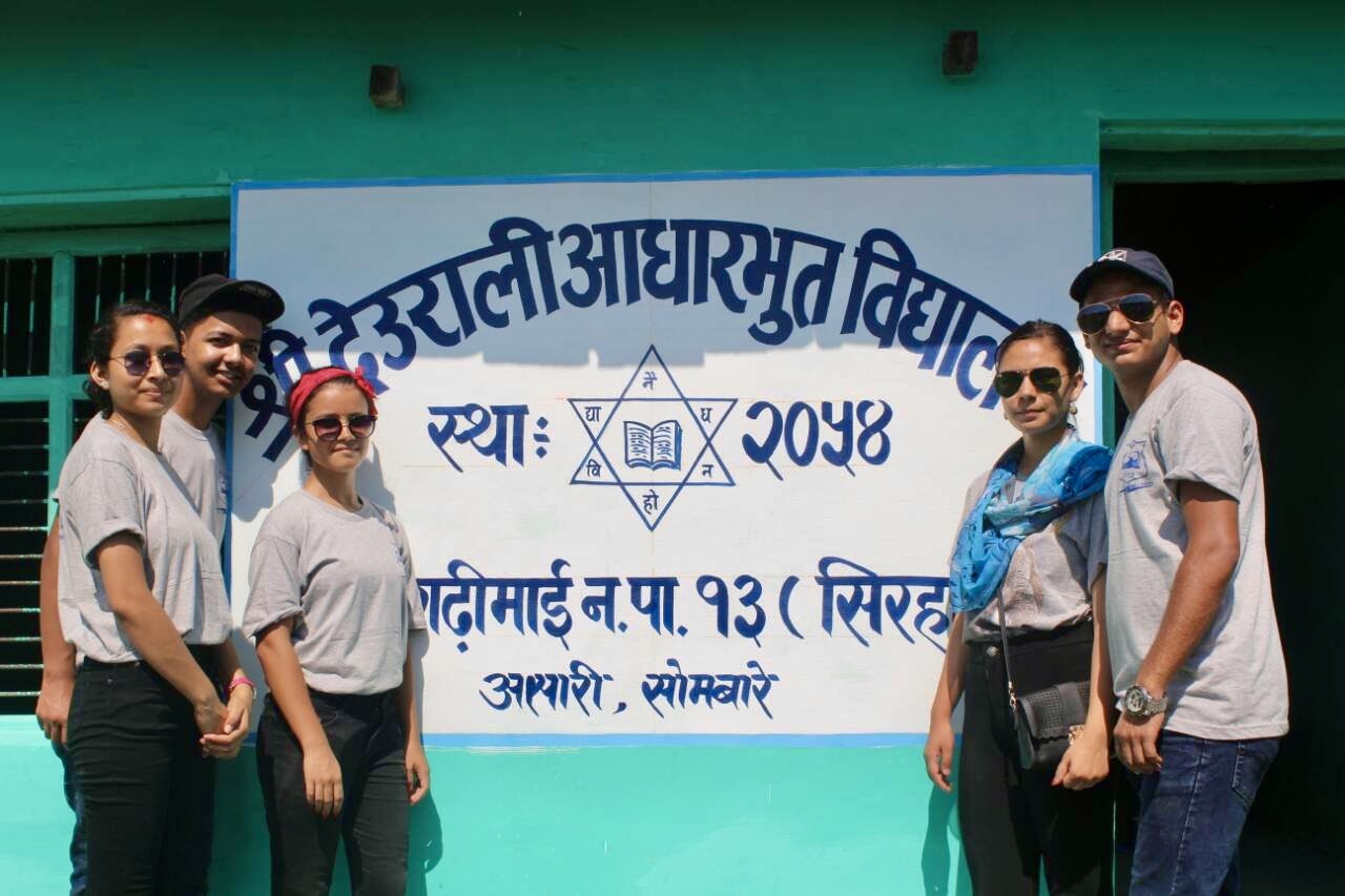 Students and volunteers around a Book For A Cause library collection